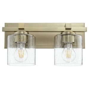 5669 Cylinder Lighting Series 2-Light Wall Mount in Aged Brass w with Clear/Seeded